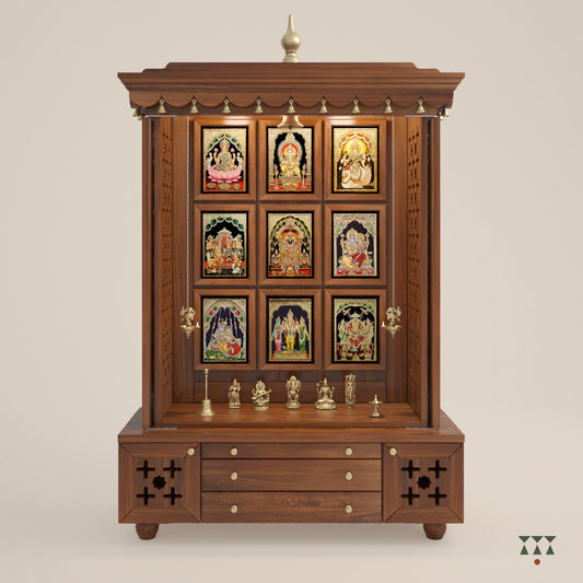 A solid wood mandir with pure brass bells, Tanjore art prints, cutwork designs and storage, tinted in an almond brown color