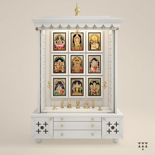 A solid wood mandir with pure brass bells, Tanjore art prints, cutwork designs and storage, tinted in a snow-white color