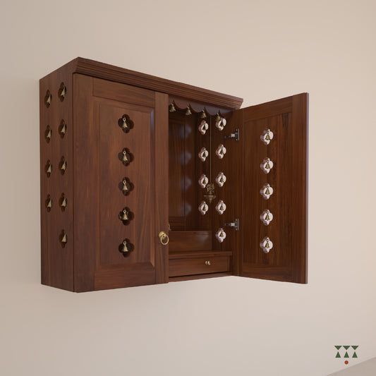A solid wood mandir with doors, pure brass bells, accessories, cutwork designs and storage tinted in almond brown