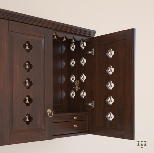 A solid wood mandir with pure brass bells, accessories, cutwork designs and storage tinted in tamarind brown