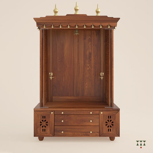 A solid wood mandir with doors, pure brass bells, accessories, cutwork designs and storage, tinted in an almond brown color