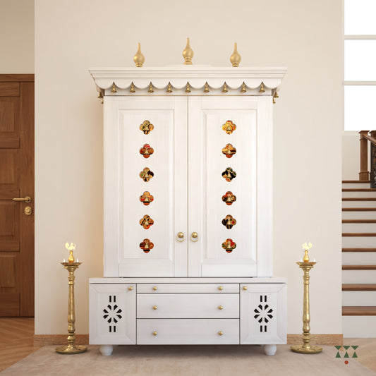 A solid wood mandir with doors, pure brass bells, accessories, cutwork designs and storage, tinted in a snow-white color