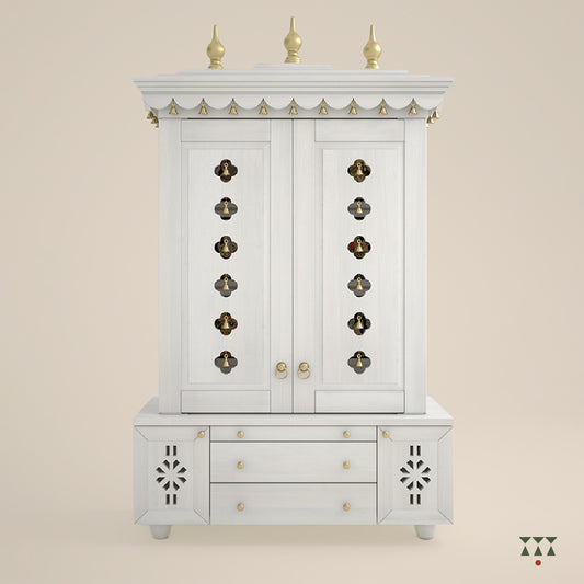 A solid wood mandir with doors, pure brass bells, accessories, cutwork designs and storage, tinted in a snow-white color
