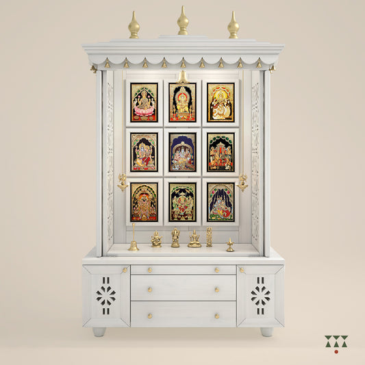 A solid wood mandir with pure brass bells, Tanjore art prints, cutwork designs and storage, tinted in a snow-white color
