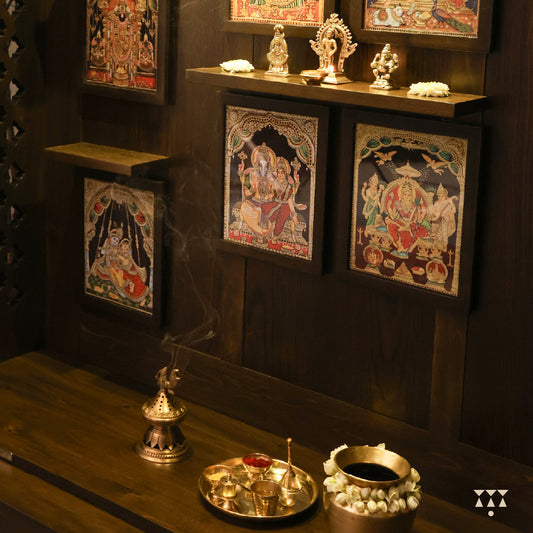 A solid wood mandir with pure brass bells, framed art prints, etched designs and storage, tinted in a mocha brown color