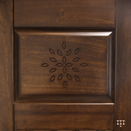 Close up etched patterns on solid wood of a handcrafted mandir tinted in mocha brown