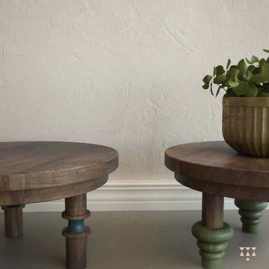 Plants displayed on a set of 3 low, solid wood accent tables with turned legs and contrasting tints