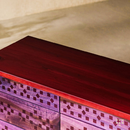 Handmade chest of drawers with a purple tinted facade inspired by Indian textiles with a bold red top