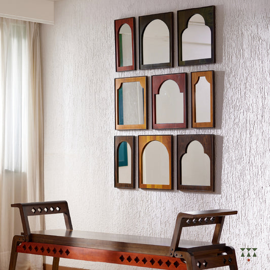 9 individual wood framed mirrors, with arch shapes tinted in moringa green, saffron orange, mustard yellow & mocha brown