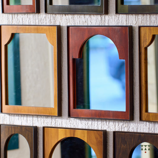 9 individual wood framed mirrors, with arch shapes tinted in moringa green, saffron orange, mustard yellow & mocha brown