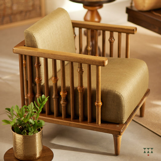A solid wood statement chair with the arm and backrest made of multiple turned spindles, upholstered in rich colorful silk
