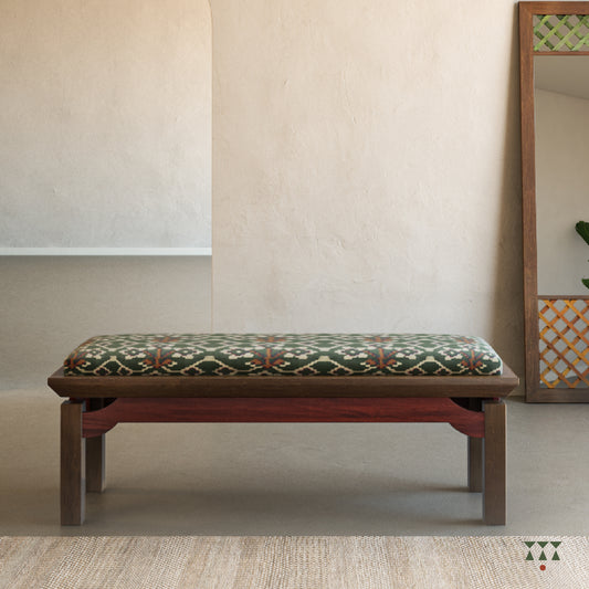 An artisanal solid wood bench with an upholstered seat in a printed Kilim fabric and legs in a tinted accent color