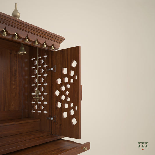 A tall wooden mandir with doors, pure brass elements, cutwork designs and storage, tinted in almond brown