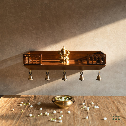 Wooden Wall mounted temple shelf with brass bells, brass bowl with jasmine flowers.