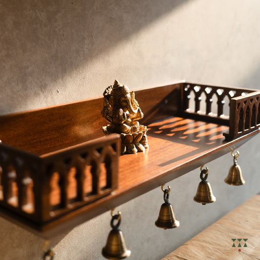 Wooden Wall mounted temple shelf with Cut out details and brass bells.