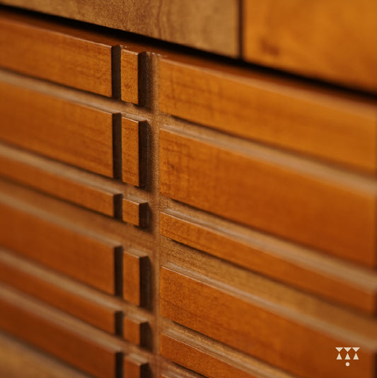 Close up of the facade of a chest of drawers textured with Madras checks patterns, tinted in Mocha Brown & Mustard Yellow