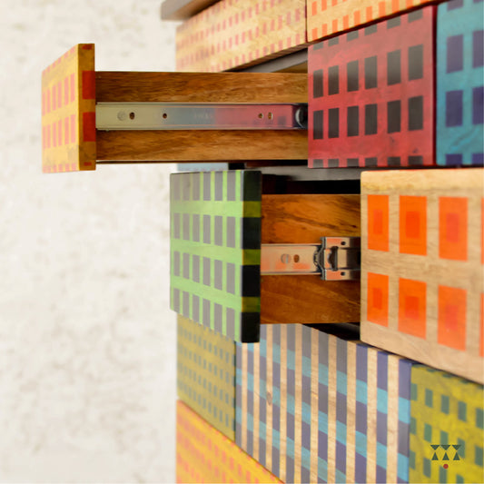Colorful wooden drawers with geometric patterns on a light background
