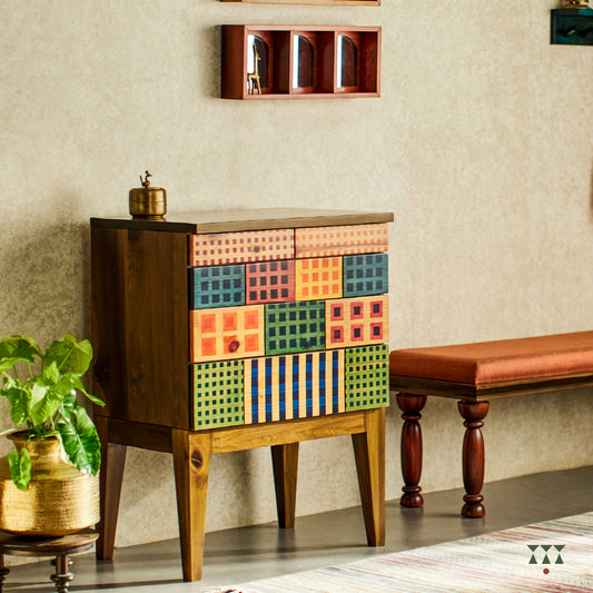 A petite chest of drawers with vibrant facade inspired by the color blocks of Madras check textiles, crafted in solid wood