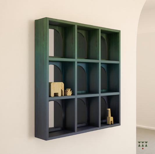 Perspective of a wooden mirror with 9 cubbies and arch patterns tinted in Moringa Green, Lagoon & Cobalt Blue
