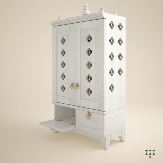 A solid wood mandir with doors, pure brass elements, cutwork designs and storage, tinted in snow white
