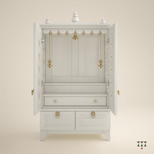 A solid wood mandir with doors, pure brass elements, cutwork designs and storage, tinted in snow white