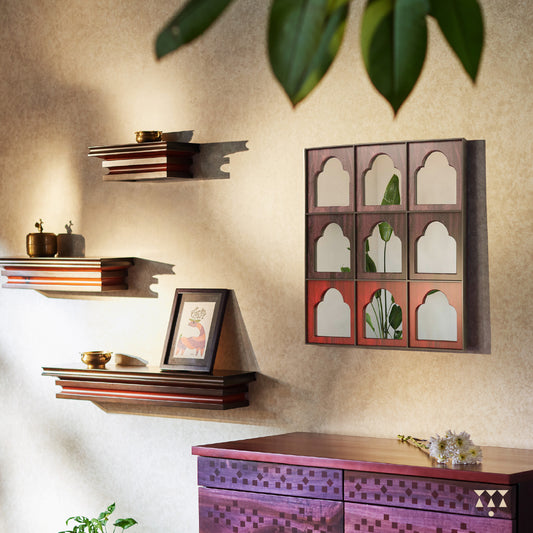 A lifestyle image of a set of 3 layered console shelves of various sizes tinted in Mocha Brown with a Saffron Orange accent
