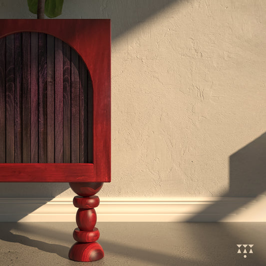 Close up of a box planter tinted with a red and purple accent, layered with arch shapes and turned legs