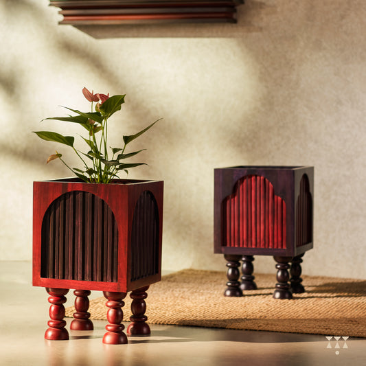 Set of 2 solid wood planters layered with arch shapes and alternating purple and red tints with turned legs