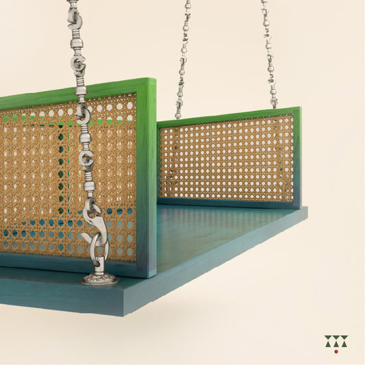 A wooden swing with weaving, tinted in Aqua Blue & Leaf Green with decorative brass chains