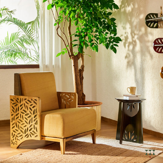 Lifestyle image of a wooden statement chair with cutwork armrest panels, silk fabric and Sand Brown & Moringa green tints
