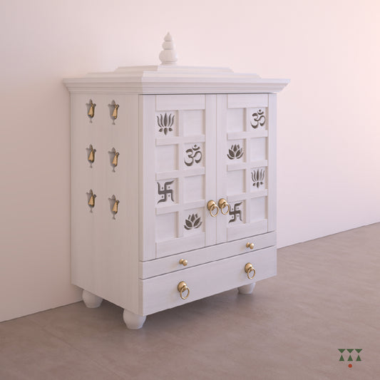A solid wood mandir with doors, pure brass bells, framed art prints, cutwork designs and storage, tinted in snow white