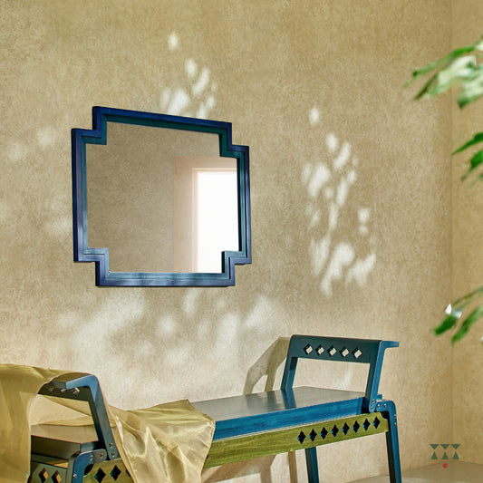 A large wall mirror with unique inverse edges layered with blue accents, handcrafted in solid wood