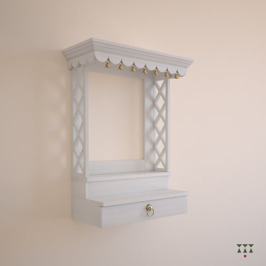 A wooden, wall mounted Mandir with clean lines, steps, storage and pure brass elements tinted in snow white