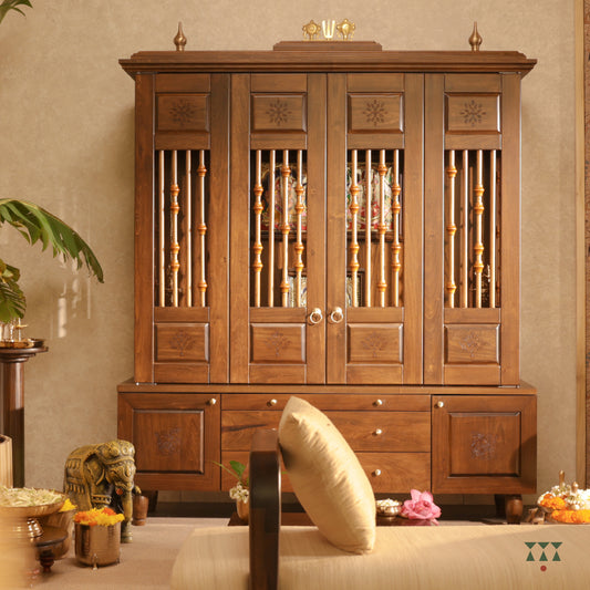 Pooja room set focusing on a solid wood mandir with doors in etched designs and turned spindles housing art frames