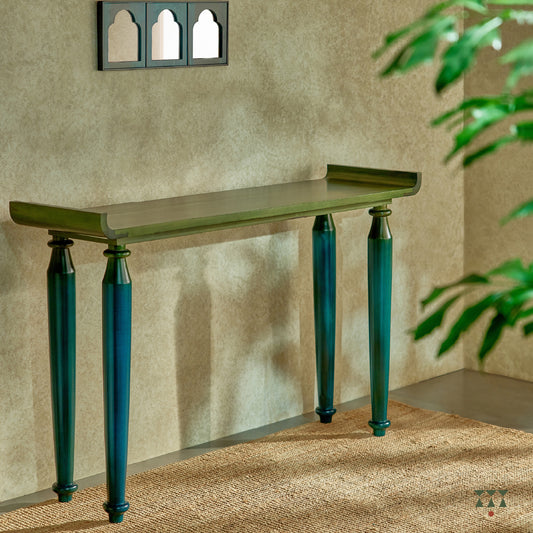 Sculptural console with curved edges and turned legs handcrafted in solid wood, tinted in Lagoon Blue & Moringa Green