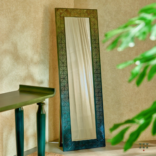 A solid wood full length mirror with a stand and a geometric, textured frame tinted in Moringa Green & Lagoon Blue