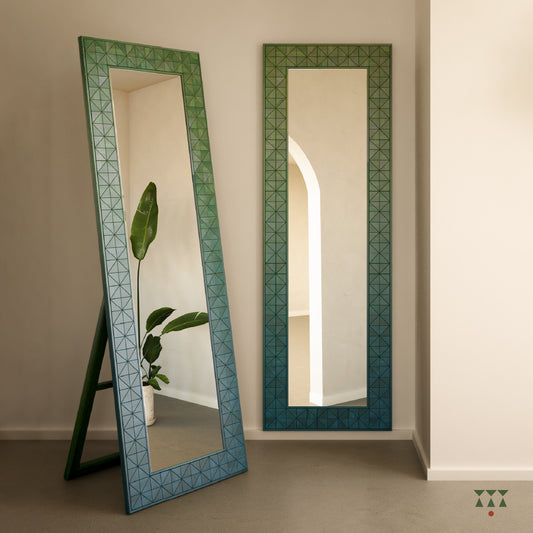 A solid wood full length mirror with a stand and wall option and a textured frame tinted in Moringa Green & Lagoon Blue
