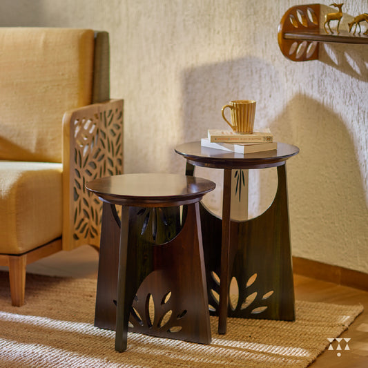 Solid wood end tables with a cutwork design and intersecting legs tinted in Mocha Brown with a Moringa Green accent
