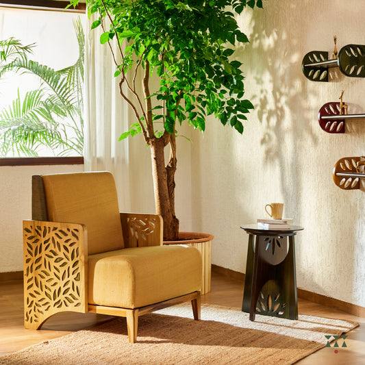Lifestyle image of a wooden end table with cutwork and intersecting legs tinted in Mocha Brown with a Moringa Green accent