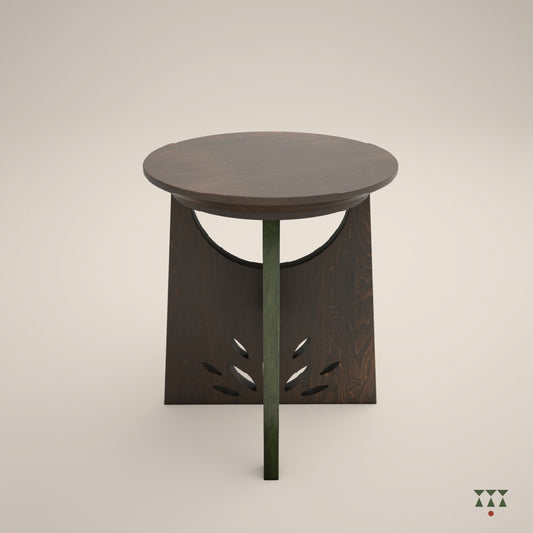 A single solid wood end table with a cutwork design and intersecting legs tinted in Mocha Brown with a Moringa Green accent