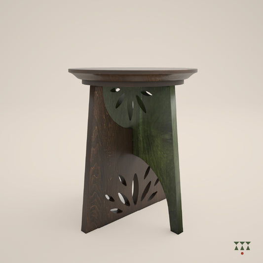 A single solid wood end table with a cutwork design and intersecting legs tinted in Mocha Brown with a Moringa Green accent