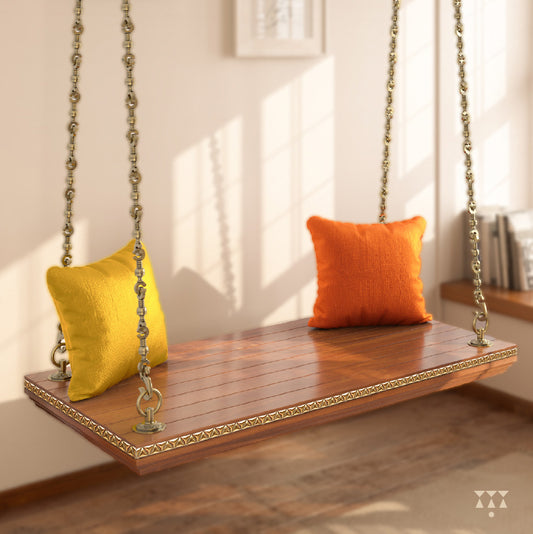 A handcrafted wooden swing base tinted in almond brown with decorative edging, brass chains and cushions