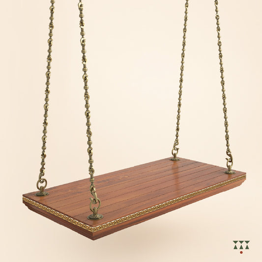 A handcrafted wooden swing base tinted in almond brown with decorative edging and brass chains