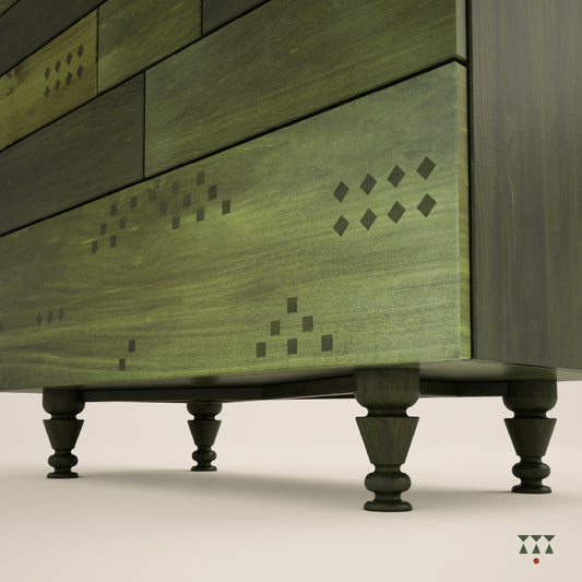 Close up of the legs of a chest of drawers with a facade inspired by Indian textiles, tinted in Moringa & Forest Green