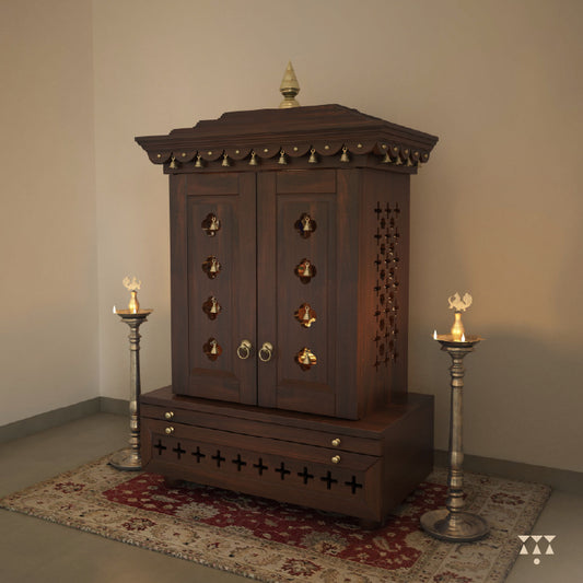 A wooden mandir with doors, pure brass elements, cutwork designs and storage, tinted in tamarind brown