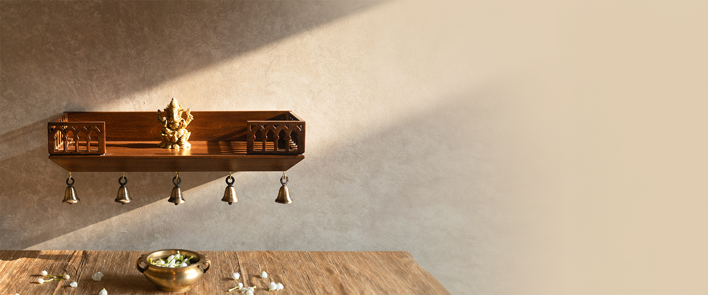 Decorative wall mount mandir with small idol on it with a neutral background