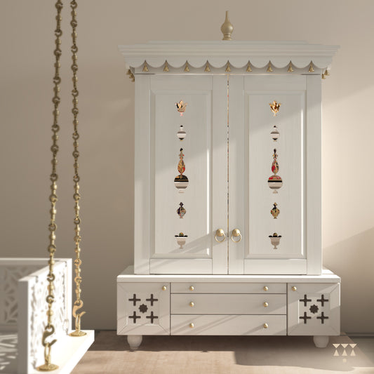 A solid wood mandir with doors, pure brass bells, accessories, cutwork designs and storage, tinted in a snow-white color