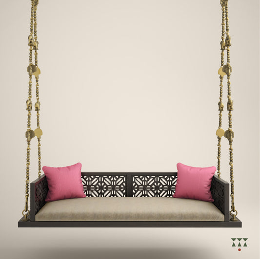 A wooden swing with cutwork, tinted in slate black with a decorative brass chain and animal motifs, fabric seat and cushions