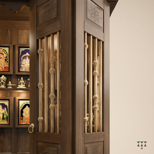 A solid wood mandir with pure brass bells, framed art prints, etched designs and storage, tinted in a mocha brown color