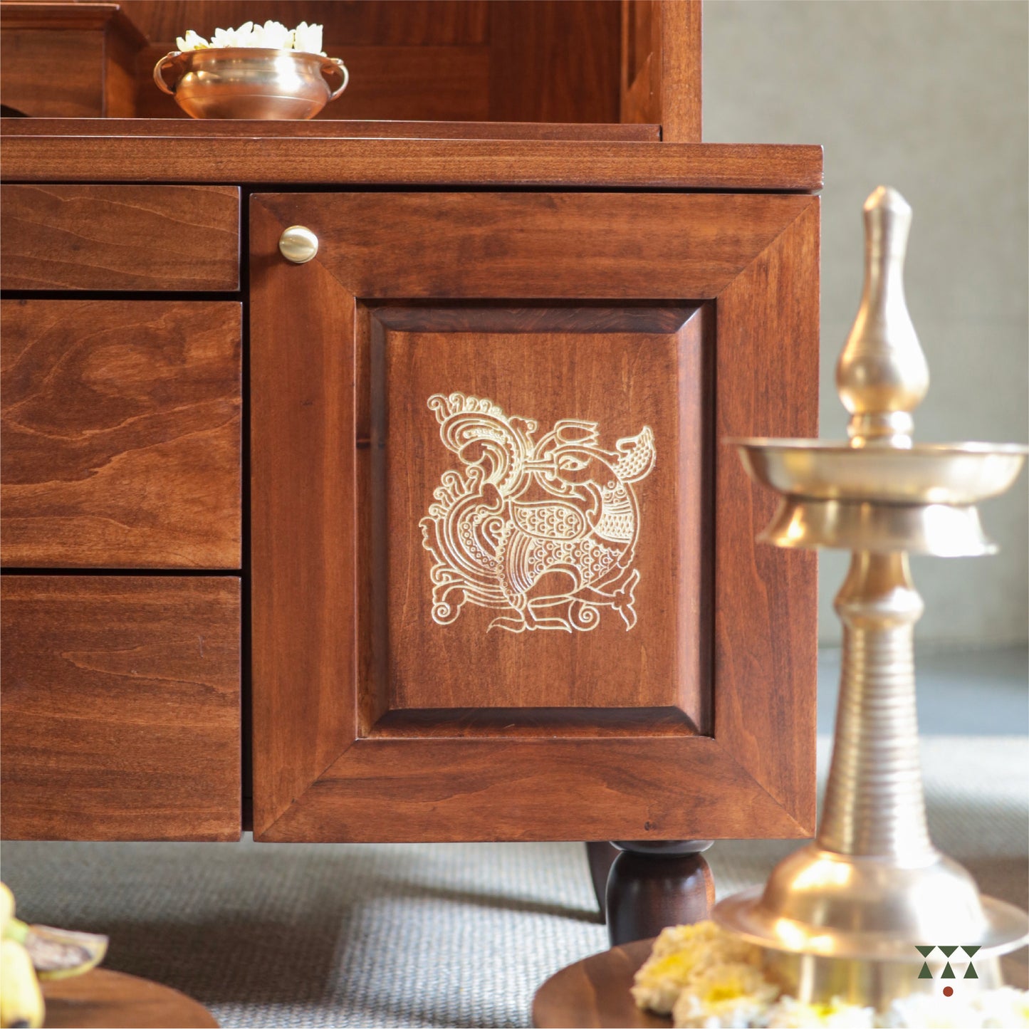 Wooden pooja mandir with intricate carvings and gold accents, featuring an annapakshi motif